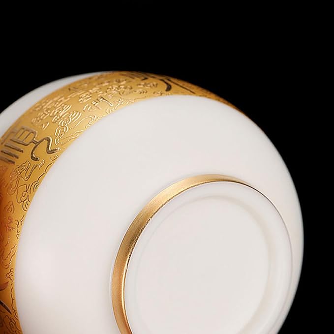 Traditional Chinese mutton-fat jade teacups, decorated with gold leaf patterns; white ceramic teacups with gilded interiors; and handcrafted tea bowls. (SHUN - White)