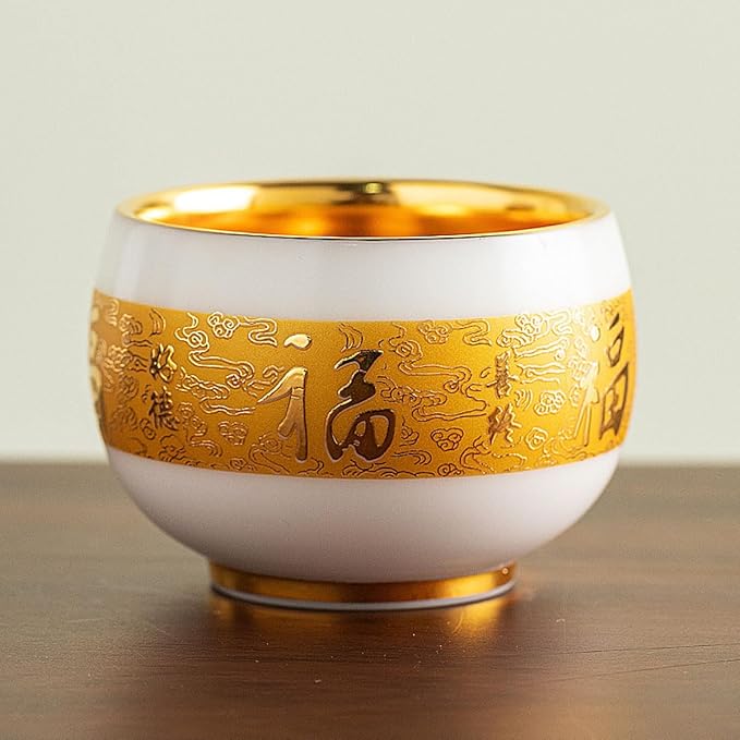 Traditional Chinese mutton-fat jade teacups, decorated with gold leaf patterns; white ceramic teacups with gilded interiors; and handcrafted tea bowls. (FU - Gold)