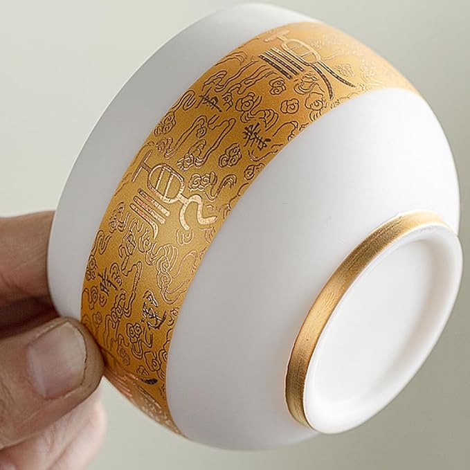Traditional Chinese mutton-fat jade teacups, decorated with gold leaf patterns; white ceramic teacups with gilded interiors; and handcrafted tea bowls. (FU - Gold)