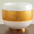 Traditional Chinese mutton-fat jade teacups, decorated with gold leaf patterns; white ceramic teacups with gilded interiors; and handcrafted tea bowls. (SHUN - White)