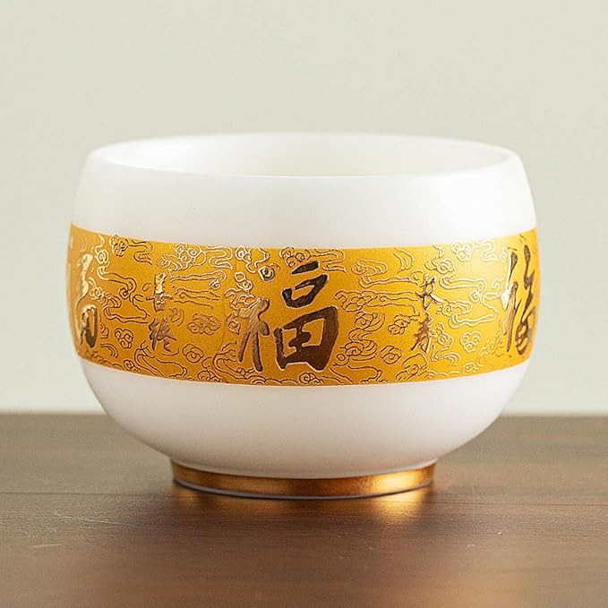 Traditional Chinese mutton-fat jade teacups, decorated with gold leaf patterns; white ceramic teacups with gilded interiors; and handcrafted tea bowls. (FU - white)